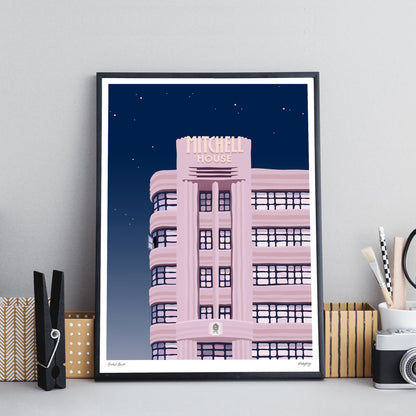 Colourful art print of Mitchell House Melbourne at night starry sky black framed print on office desk